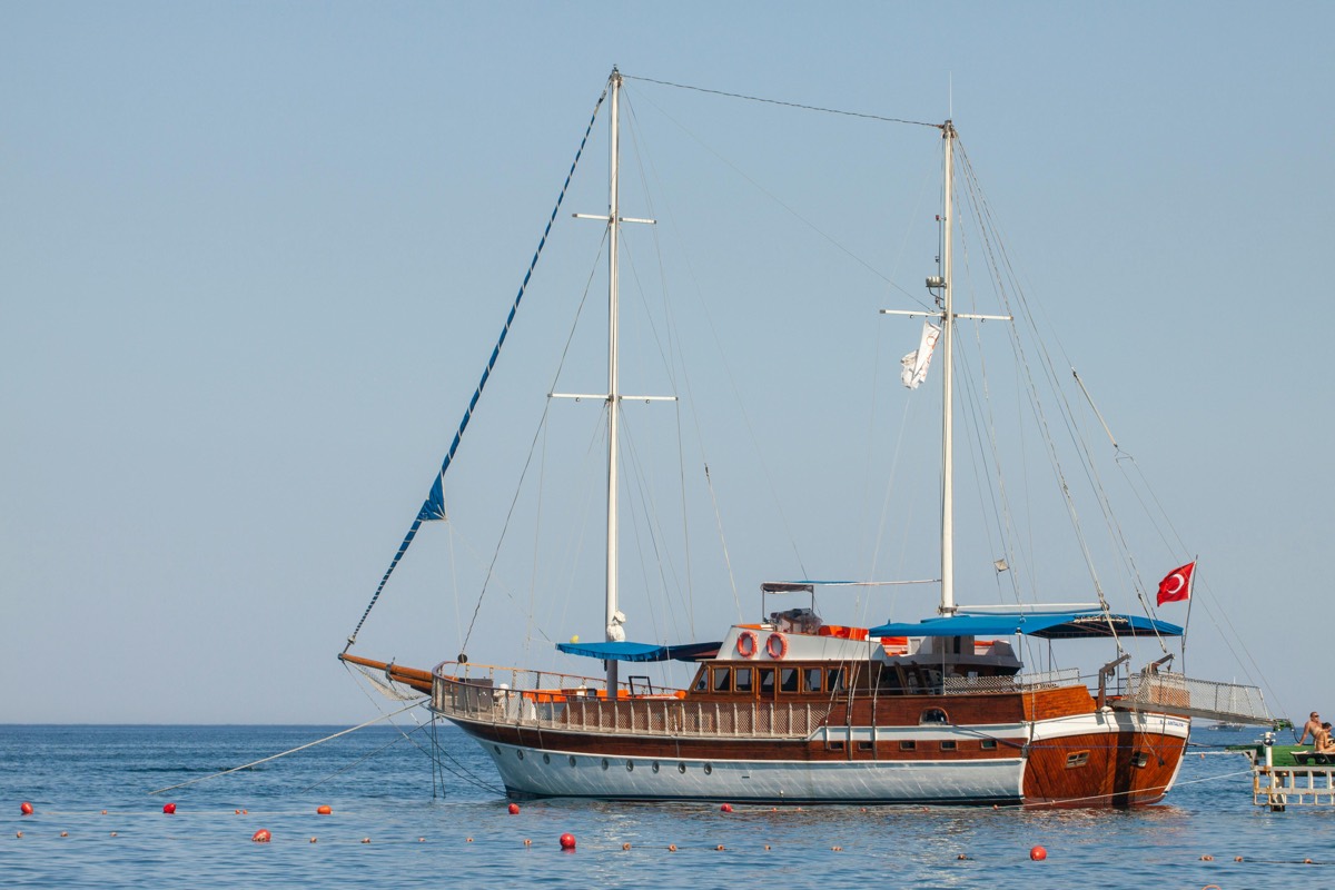 A wooden gulet anchored in a bay